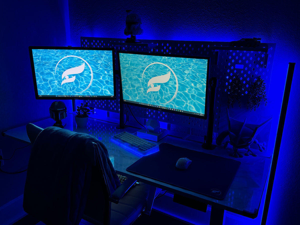 Aurora65 LITE Nebula Blue keyboard with bright blue RGB underglow in a gaming setup